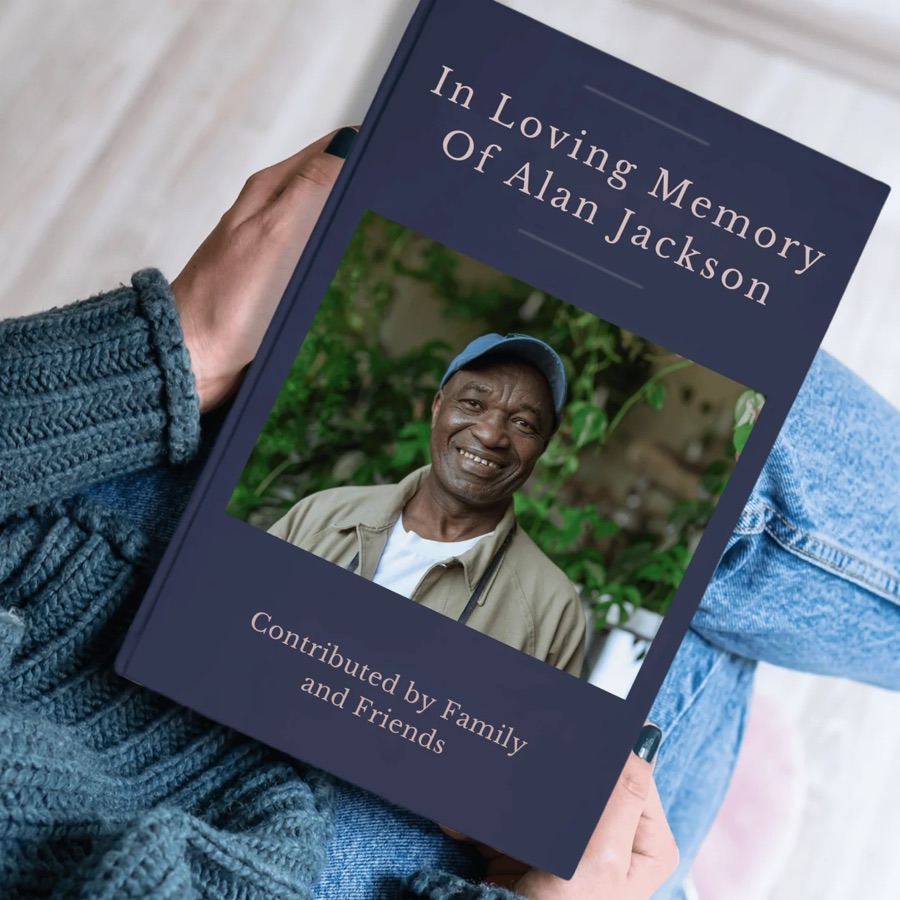 A Memorygram memorial tribute book held open to its personalized cover